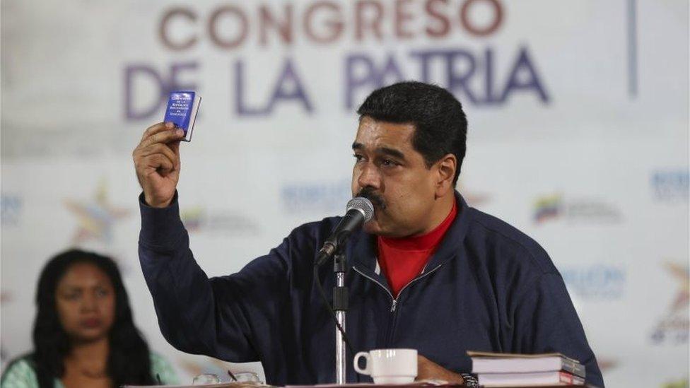 Venezuela"s President Nicolas Maduro (C) holds a copy of the country's constitution while he talks to supporters during an event at the 4F military fort in Caracas, in this handout picture provided by Miraflores Palace on January 23, 2016. REUTERS/Miraflores Palace/Handout via Reuters