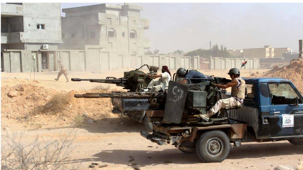 Fighters from forces aligned with Libya's new unity government fire anti-aircraft guns from their vehicles at Islamic State positions in Algharbiyat area, Sirte, June 21, 2016.