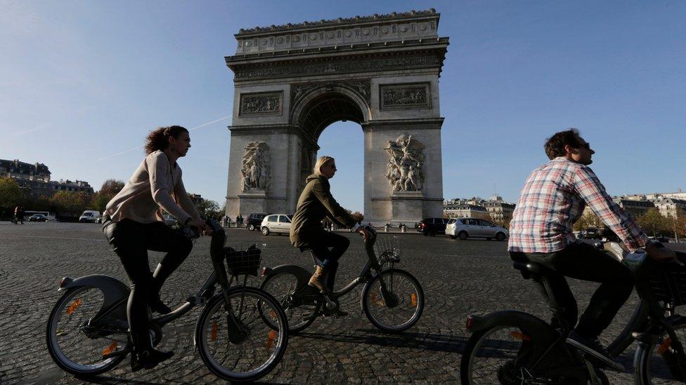 Tourists on bicycles near the Arc de Triomphe, Paris (15 November)