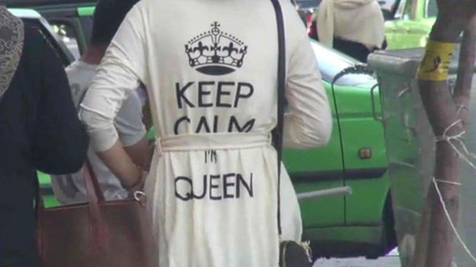 A video report by Iran's Fars news agency shows a woman with a top bearing the slogan "Keep calm, I'm queen".