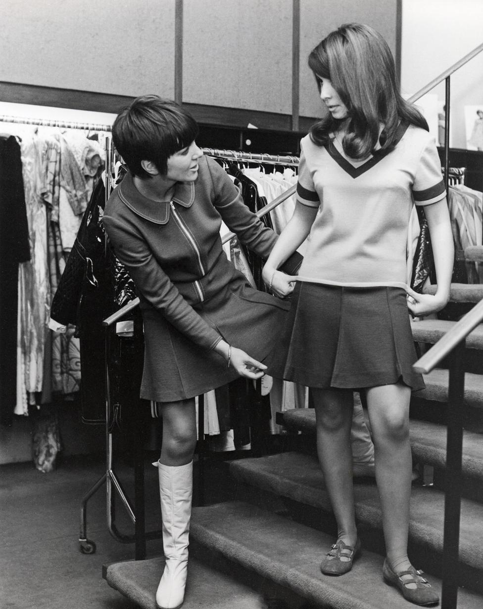 MARY QUANT UK fashion designer advises a Dutch girl client about the mini skirt which she invented at her London boutique Bazaar in 197