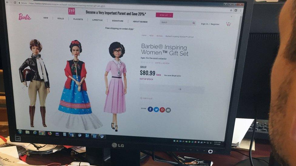 A journalist looks at the new series of Barbie dolls, "Inspiring Women", featuring (L-R) Amelia Earhart, Frida Kahlo and Katherine Johnson, on 7 March 2018 in New York