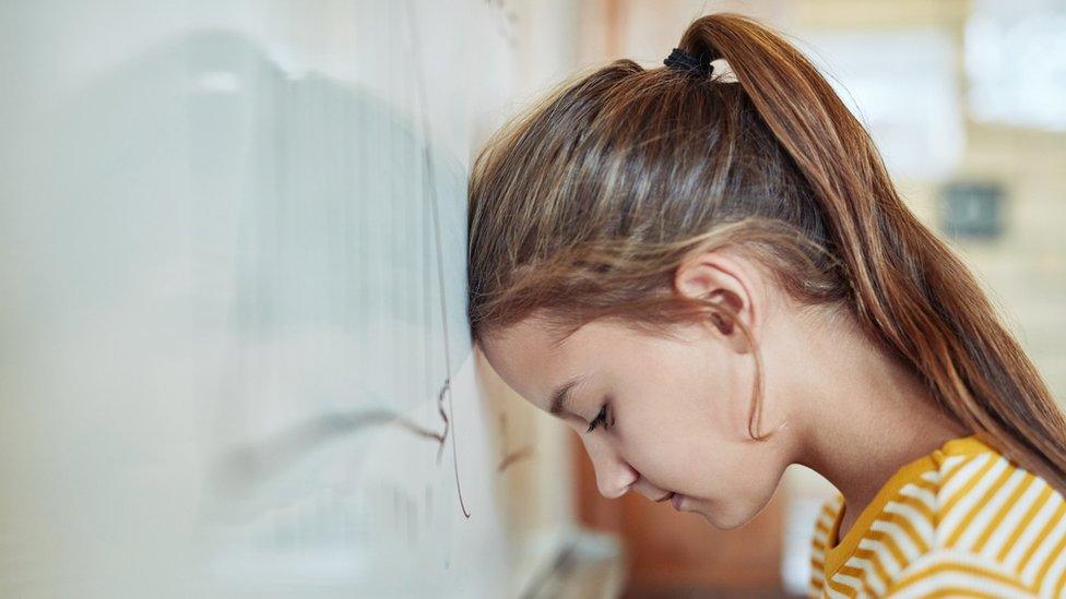 Girl with head on white board
