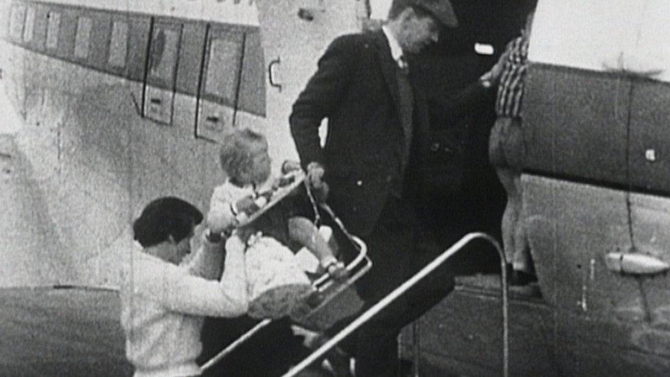 Passengers board a flight in the 1960s