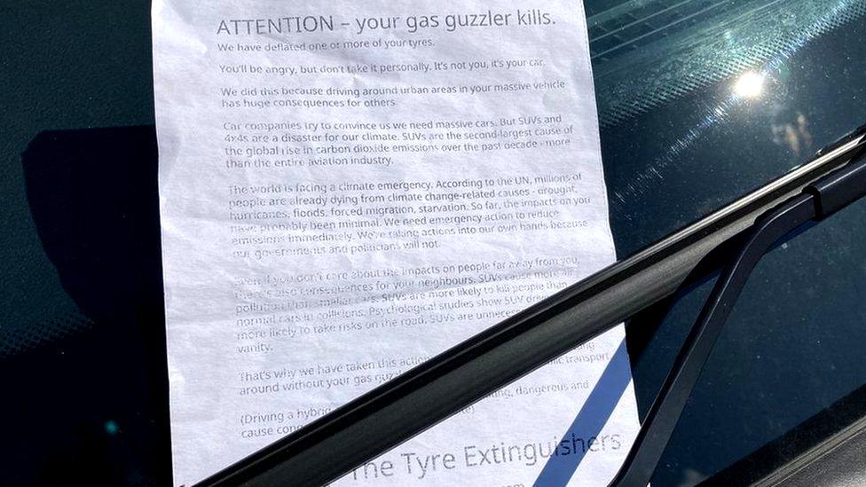 Leaflet reading "Attention - your gas guzzler kills" in windshield