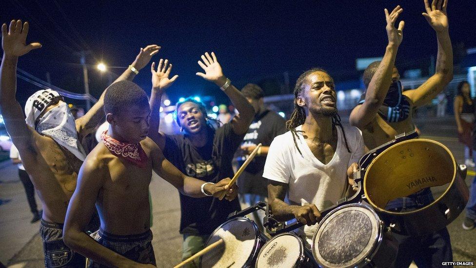 Demonstrators, marking the one-year anniversary of the shooting of Michael Brown, protest along West Florrisant Street on 10 August
