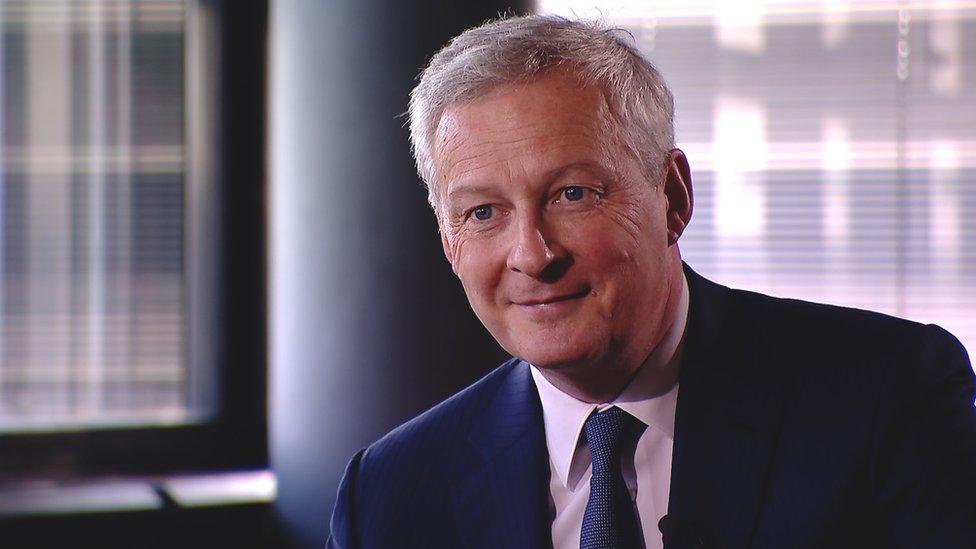 Bruno Le Maire sits facing the camera in an interview set-up