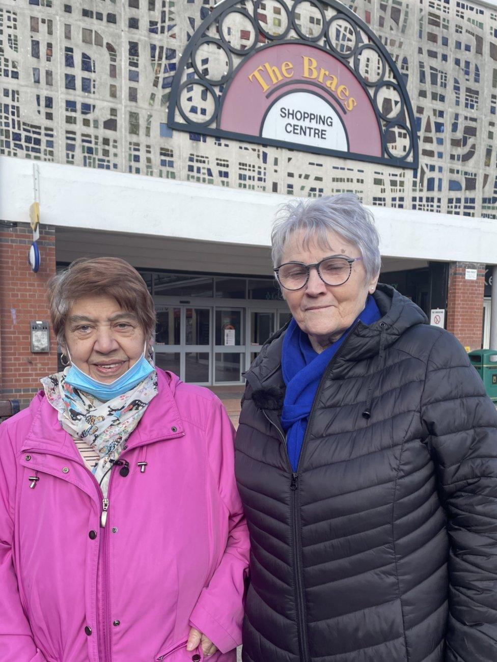 Christine Devine and Maureen Cope are standing together in the arcade