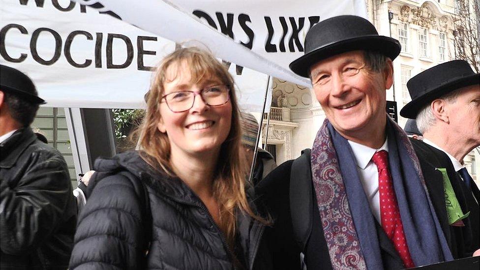 A woman and a man smiling at the camera