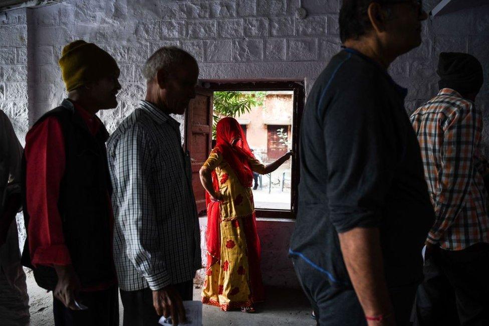 Indians, including a woman, at a polling booth