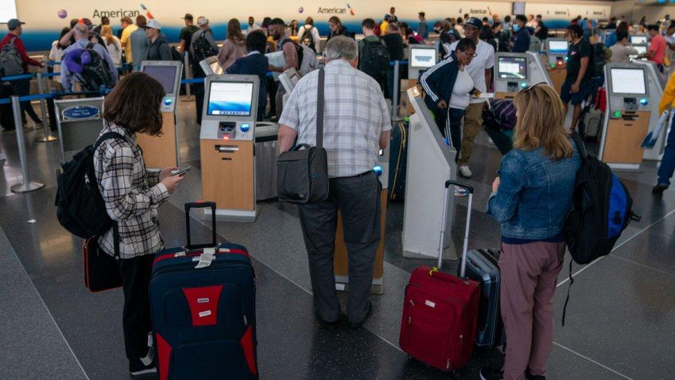 People at JFK International airport in New York City on Friday