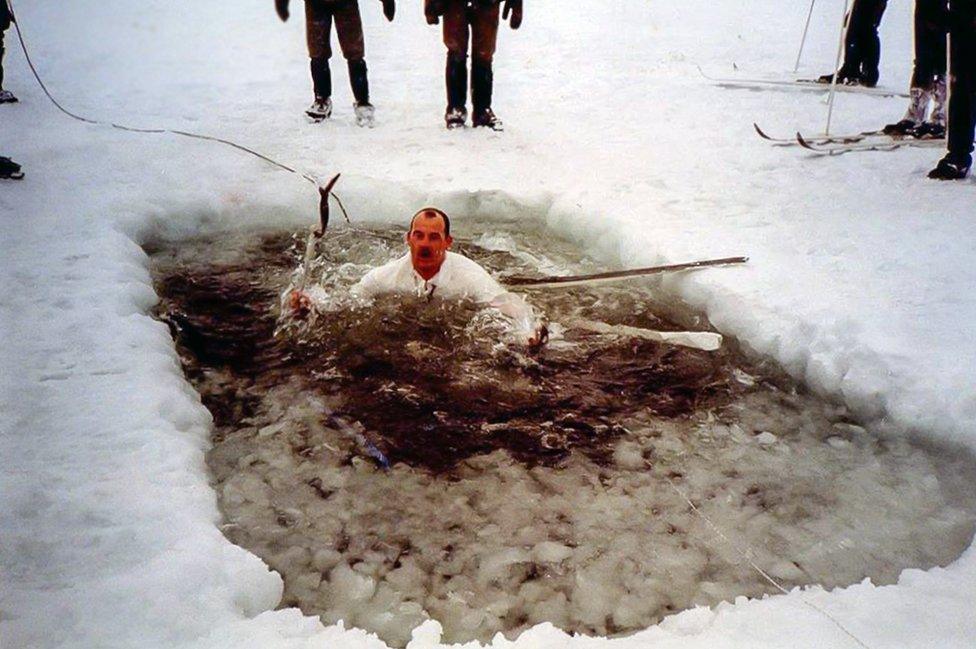 A man swimming in an ice bath