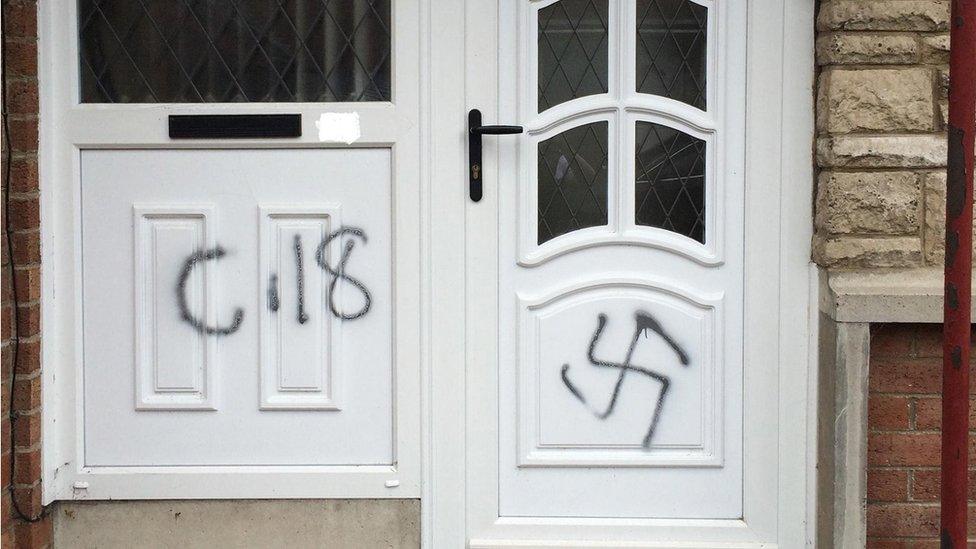 Doorway to a house in Armagh, with graffiti of a Nazi swastika and C18 - which is being treated as a hate crime