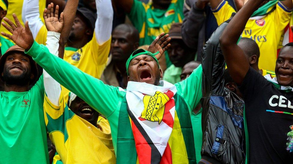 Zimbabwe"s supporters cheer their team during the AFCON Group L qualifier football match between Malawi and Zimbabwe on June 5, 2016 at the National Sports Stadium in Harare. / AFP PHOTO / JEKESAI NJIKIZANAJEKESAI NJIKIZANA/AFP/Getty Images