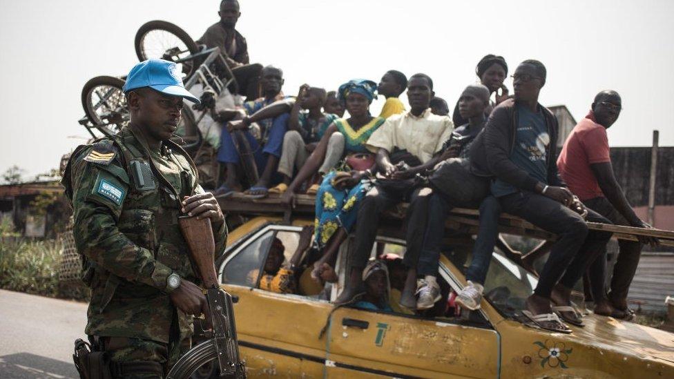 A Rwandan peace-keeper from the United Nations Multidimensional Integrated Stabilization Mission in the Central African Republic (MINUSCA) patrols the road leading to Damara, where skirmishes took place during the week on January 23, 2021