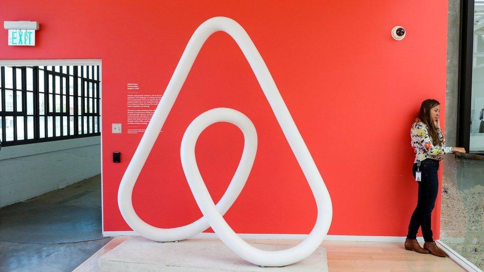 A woman talks on the phone at the Airbnb office headquarters in the SOMA district of San Francisco, California, U.S