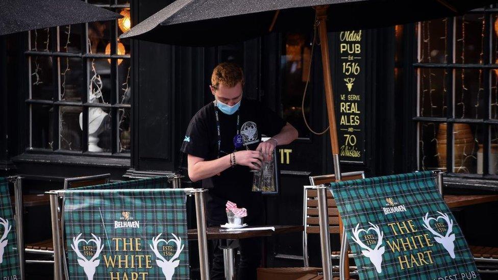 Barman outside pub