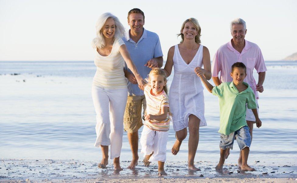 family running on beach