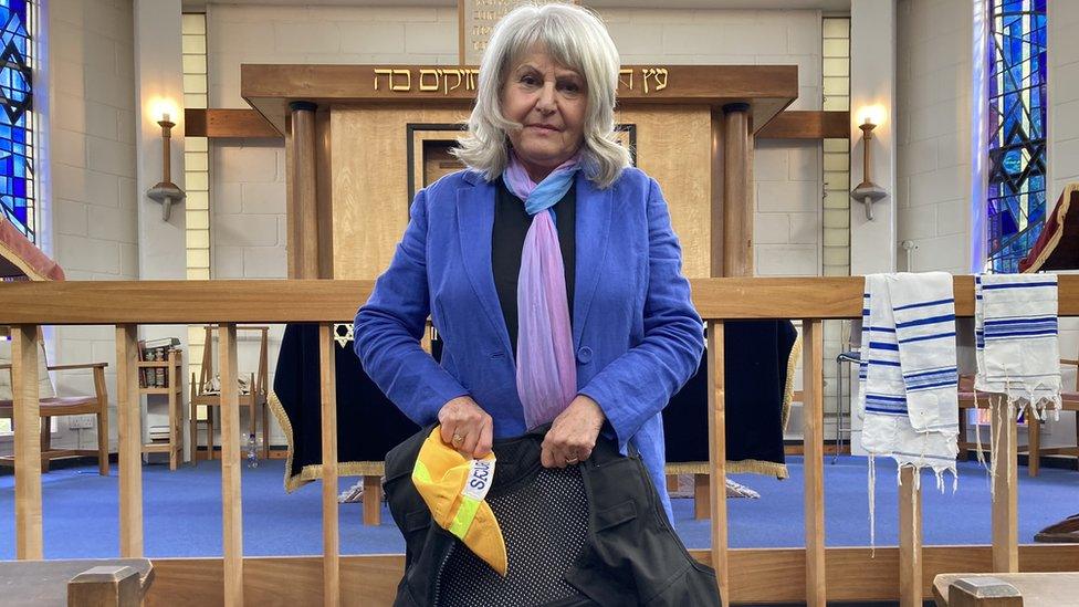 Marian Prinsley from the Norwich Synagogue seen here holding a stab proof vest