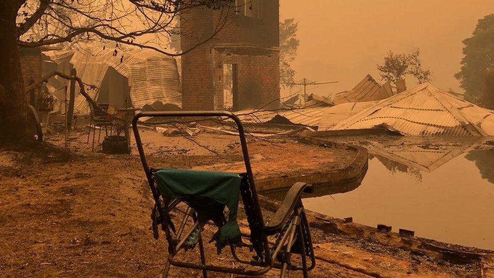 Burnt out chair in a front of a destroyed property in Mallacoota