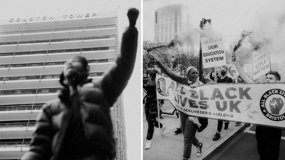 Man holding first in front of Colston Tower and the front of a BLM march