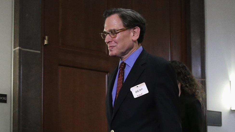 Sidney Blumenthal walks down a hall