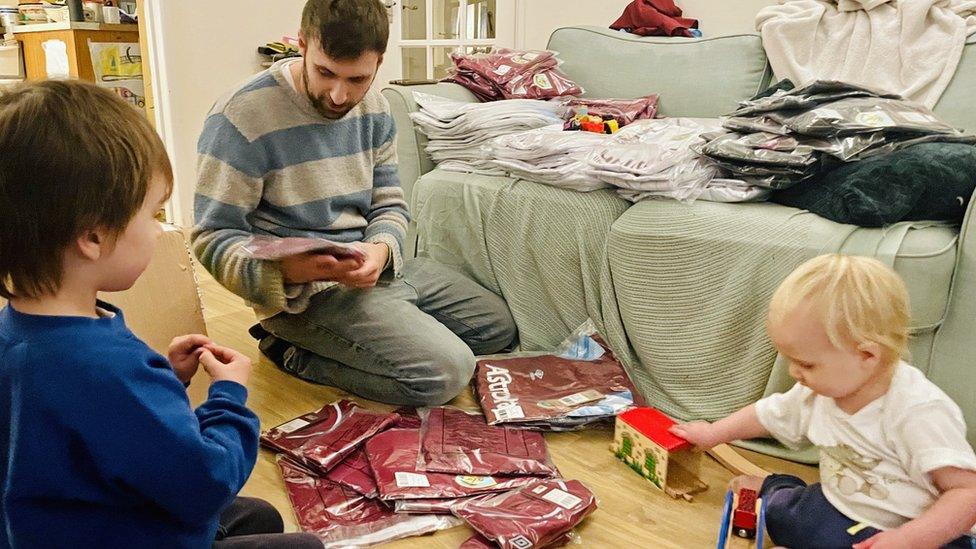 Paul Watson packing shirts with his children