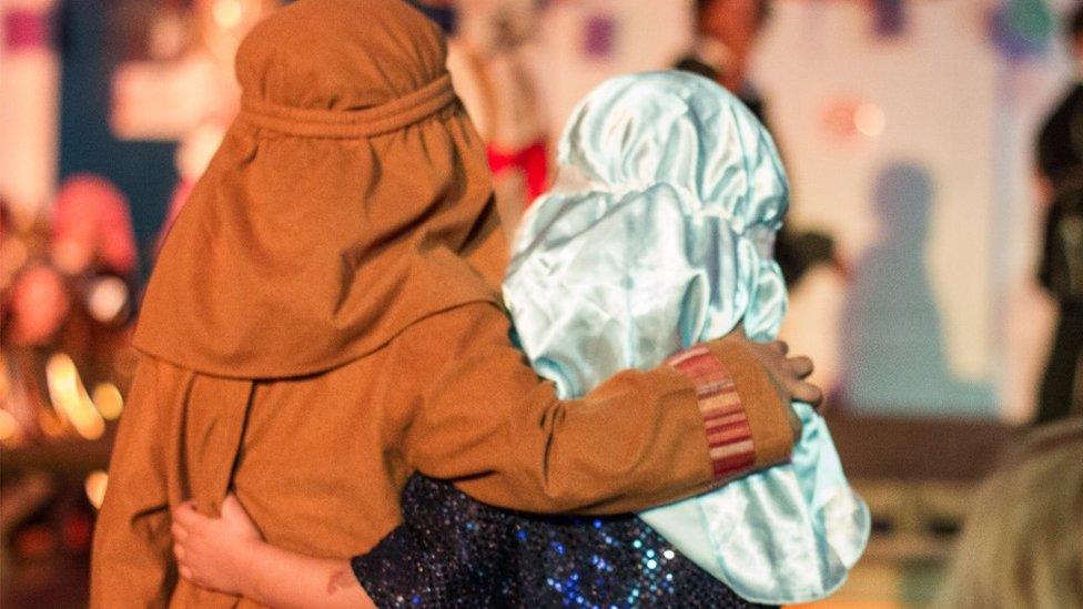 Two children dressed as Mary and Joseph