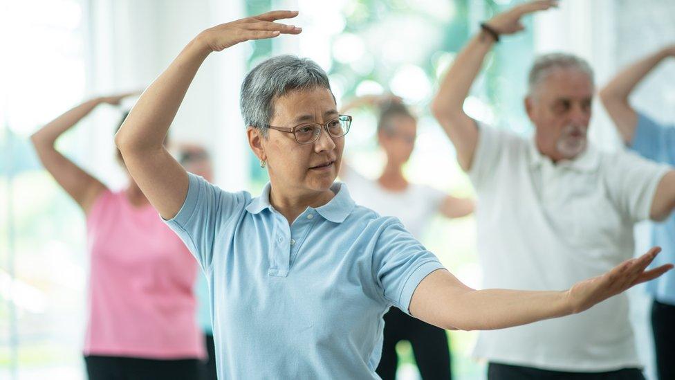 A class of people doing tai chi