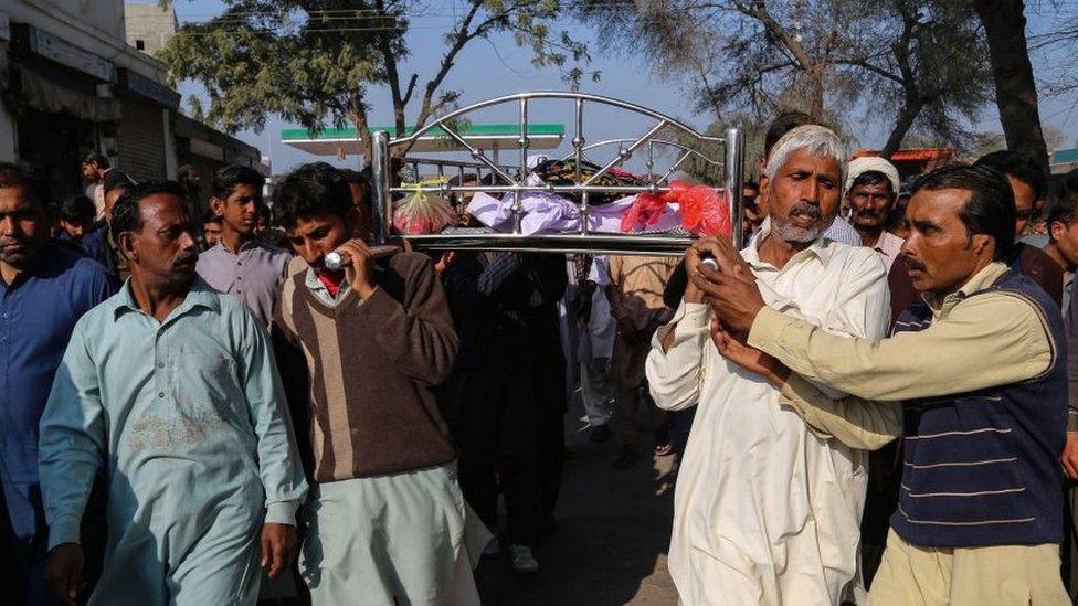 Relatives and locals carry a coffin containing the body of a man for his funeral at Khanewal district on Sunday 13 February 2022