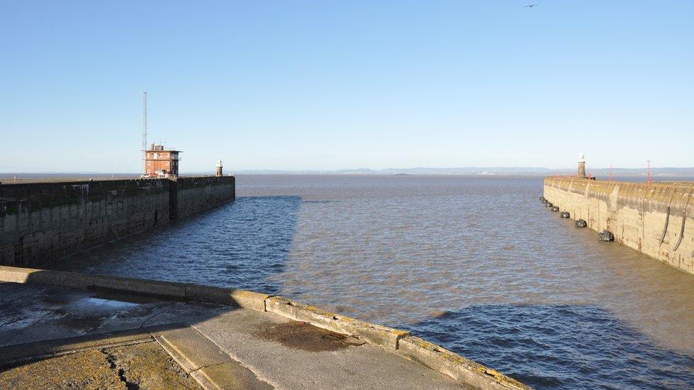 Looking out to the estuary from dockside showing the potential gap