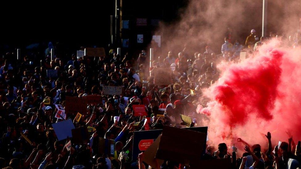 protests at super league with smoke bomb