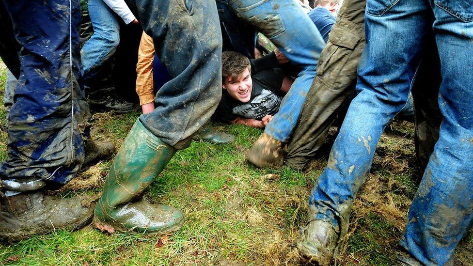 Thick of the action in the bottle kicking match