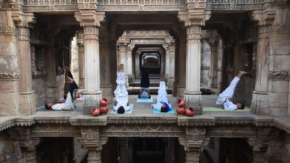 Indian yoga practitioners take part in a yoga session on International Yoga Day at the 15th century Adalaj Stepwell in Adalaj, some 40km from Ahmedabad in western Gujarat state, on June 21, 2019.