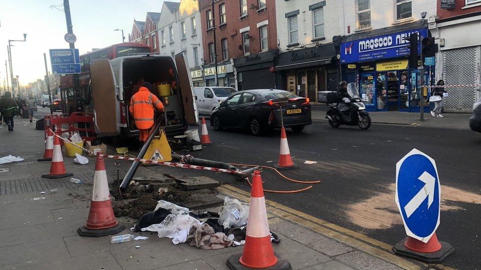 Image of a highways team repairing damage to a traffic light and post at the scene of the collision on Monday