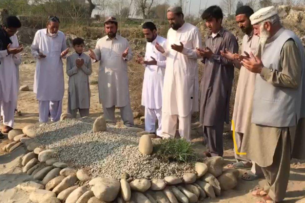 Mourners pay their respects at the graves of Ayesha and Irshad