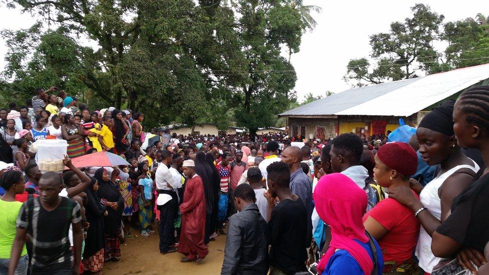 Crowds gather near the school