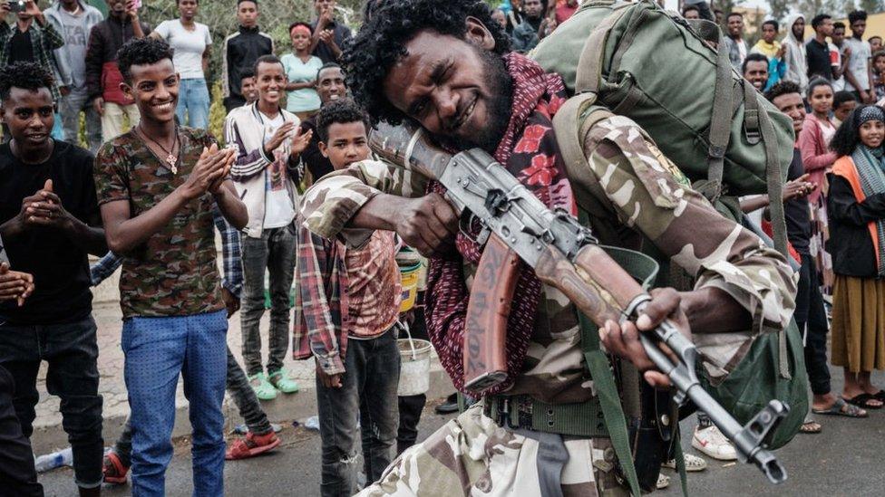 A Tigray People's Liberation Front (TPLF) fighter poses as he walks towards another field at Tigray Martyr's Memorial Monument Center in Mekele, the capital of Tigray region, Ethiopia, on June 30, 2021