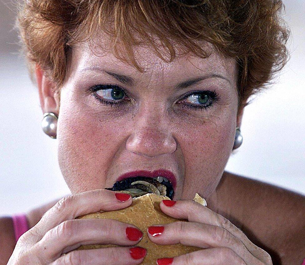 Pauline Hanson eats a burger