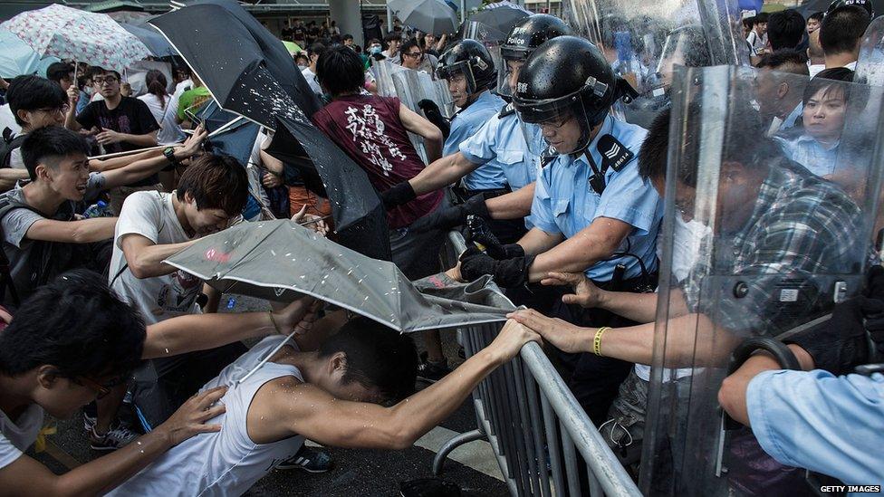 Protesters clash with riot police outside Hong Kong government complex on27 September 2014 in Hong Kong.