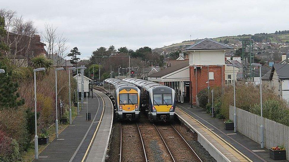 Two trains pass each other at Whitehead station