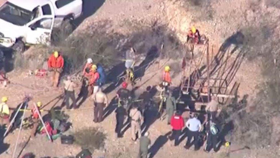 Workers prepare to descend into the mineshaft