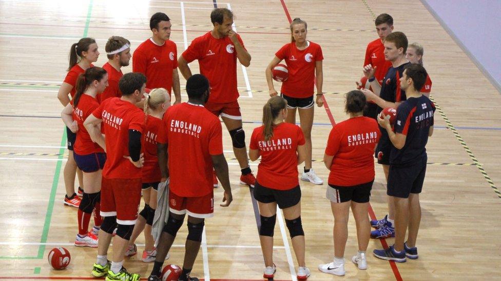 England Lions stood in a circle listening to the coach talking