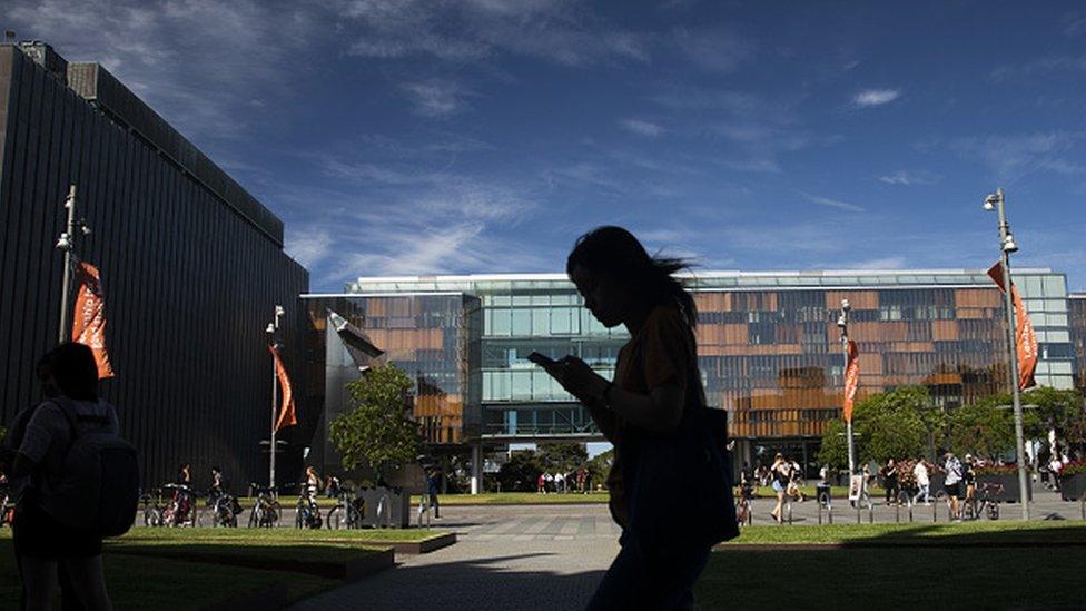 A student walks past buildings at the University of Sydney in Sydney, Australia