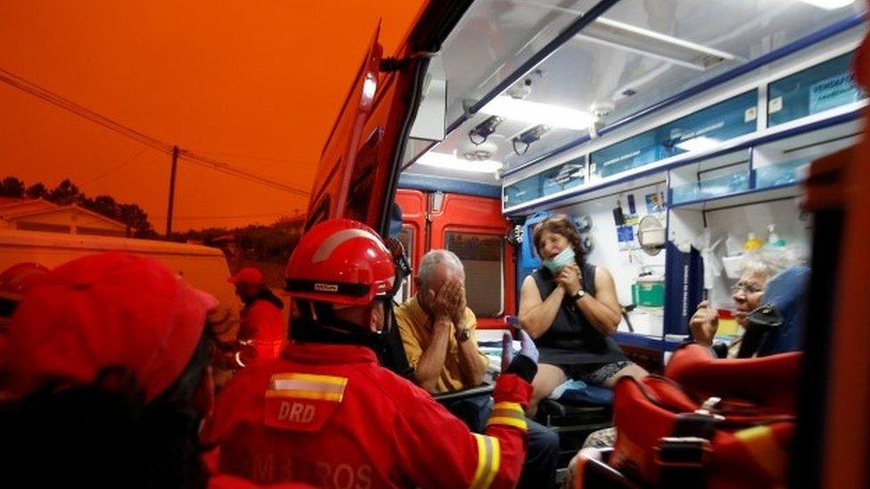 Local residents react as they are evacuated during a forest fire from the village of Derreada Cimeira, Portugal, 18 June, 2017.