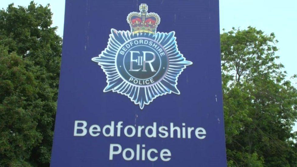 A blue Bedfordshire Police sign outside its headquarters