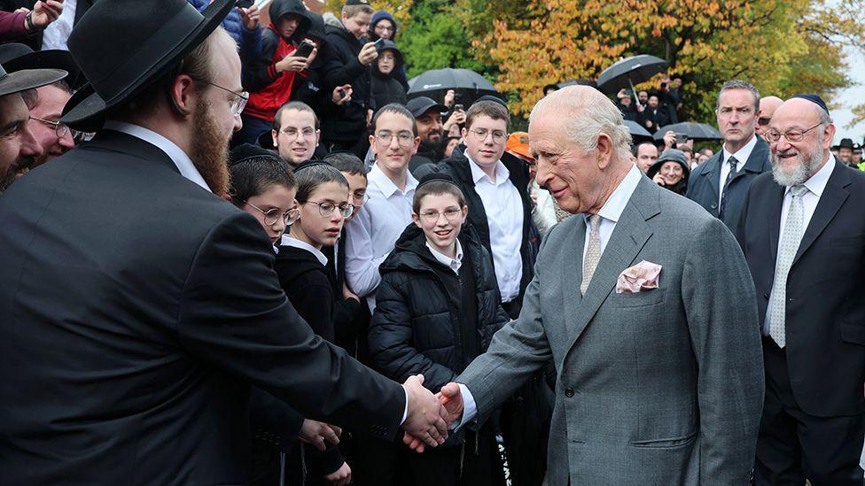 King Charles shakes hands and chats to members of the Jewish community who turned out for his visit.
