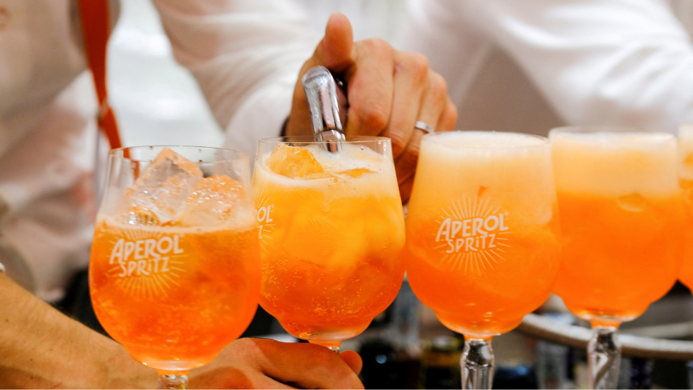 A bartender pours a drink at a Campari inauguration of a new brand house for Aperol, its best-selling beverage, in Venice Italy,
