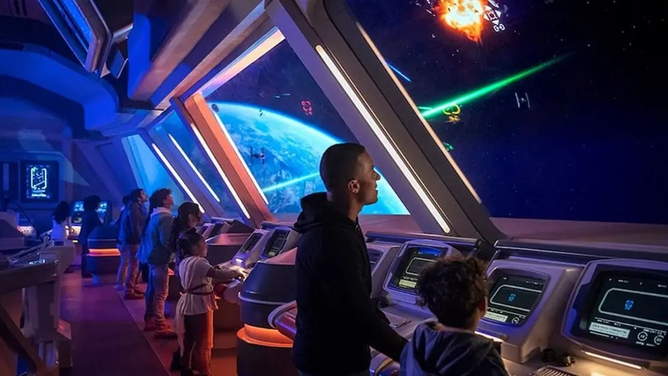 Guests at a Star Wars themed hotel interact with features made to look like they are in a space ship from the films. 