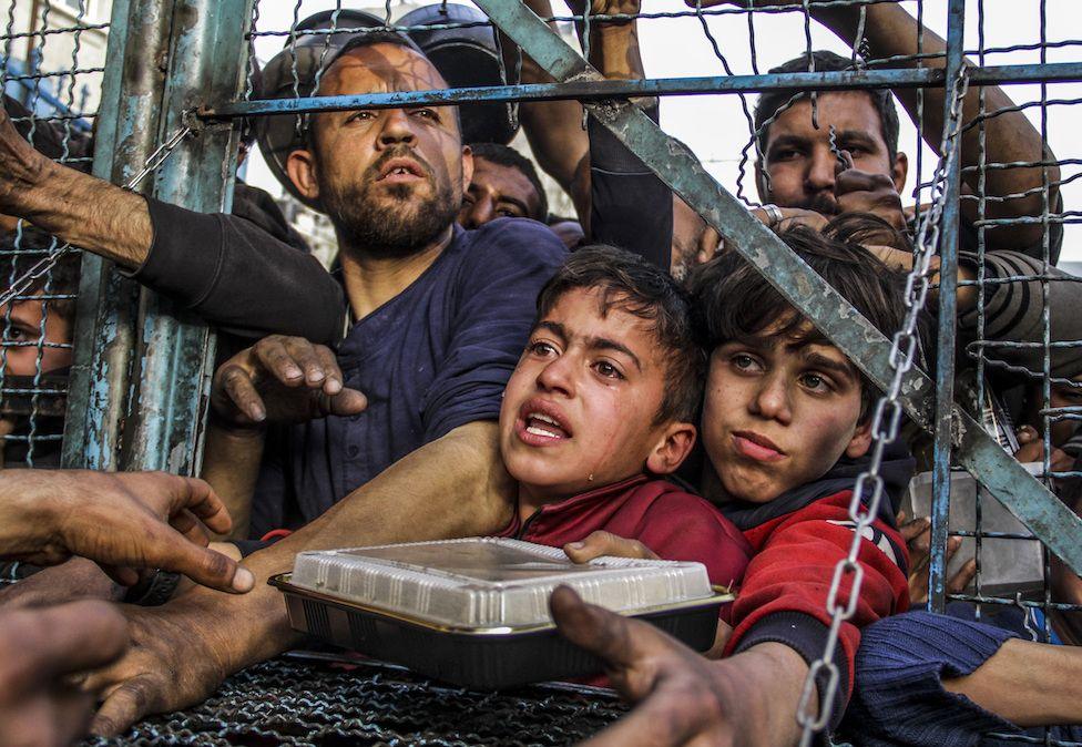 Crowd of starving Palestinians, including children, wait to receive food distributed by charity organisations in March amid Israel's blockade as the situation dramatically deteriorates in Jabalia refugee camp